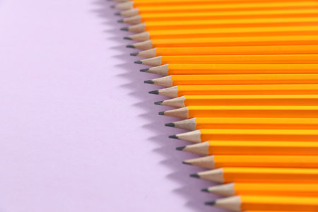 Many graphite pencils on violet background, closeup.の写真素材