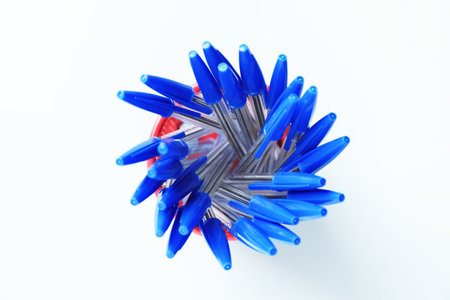 Many ballpoint pens in holder on light grey background, top viewの写真素材