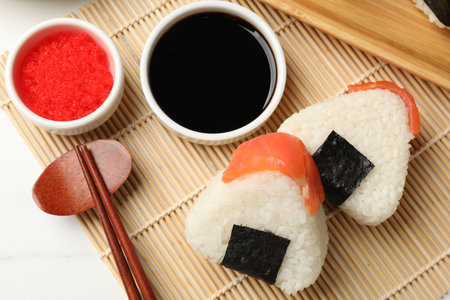 Tasty onigiri (Japanese rice balls) served on white table, flat layの写真素材