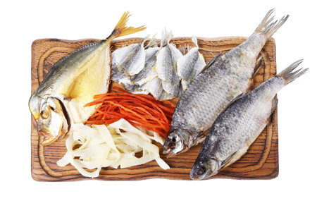 Many different dried fish snacks isolated on white, top view