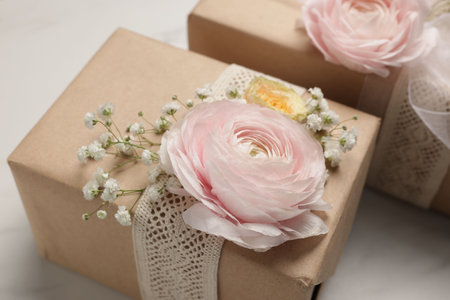 Florist. Boxes with flowers and ribbon on white marble table, closeupの写真素材