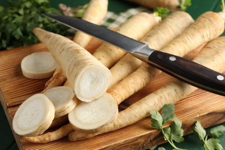 Parsley roots and leaves with knife on green table, closeupの写真素材