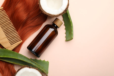 Cosmetic product, hair lock, coconut and aloe leaves on beige background, flat lay. Space for textの写真素材