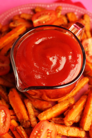 Tasty ketchup, tomatoes and fried carrots on plate, closeupの写真素材