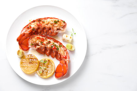 Delicious lobster tails with lemon, microgreens and green onion on white marble table, top view. Space for textの写真素材