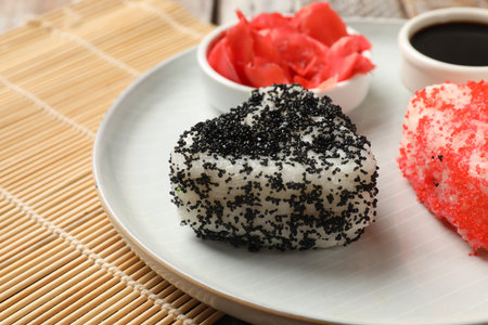 Tasty tobiko onigiri (Japanese rice balls) served on table, closeupの写真素材