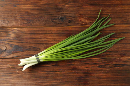 Bunch of fresh green onions on wooden table, top viewの写真素材