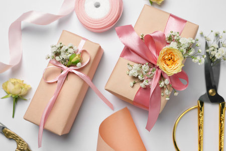 Florist. Boxes, flowers, scissors and ribbon on white background, flat layの写真素材