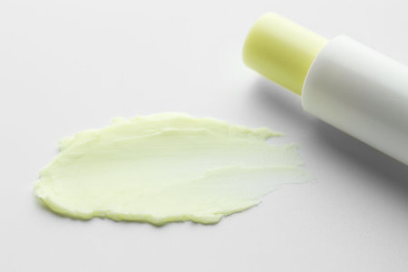 Stick of lip balm and sample on white background, closeupの写真素材