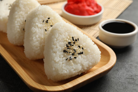 Tasty onigiri (Japanese rice balls) served on black table, closeupの写真素材