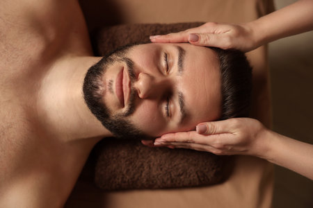 Man receiving relaxing massage in spa salon, top viewの写真素材