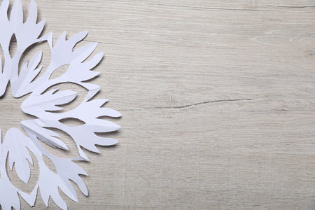 One paper snowflake on white wooden background, top view. Space for textの写真素材