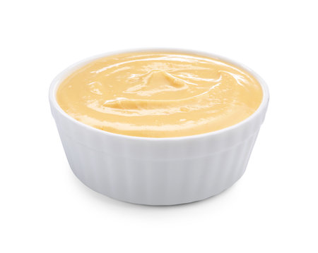 Tasty cheese dipping sauce in bowl isolated on whiteの写真素材