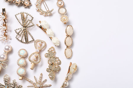 Beautiful hair clips on white background, flat lay. Space for text