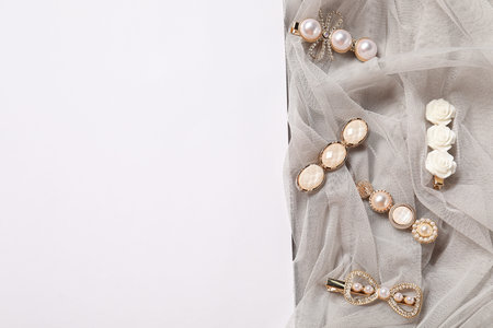 Beautiful hair clips and tulle fabric on white background, flat lay. Space for textの写真素材