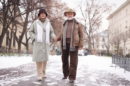 Lovely senior couple holding hands on winter dayの写真素材