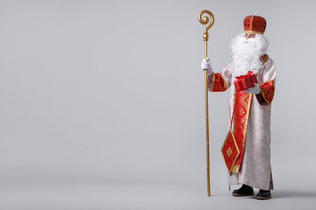 Saint Nicholas with gift on light grey background. Space for textの写真素材