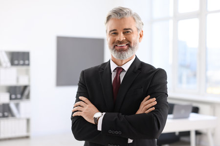 Portrait of banker with crossed arms in officeの写真素材