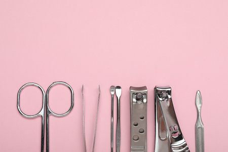 Set of different manicure tools on pink background, flat lay. Space for textの写真素材