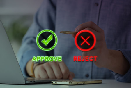 Approve or reject. Man using laptop at table, closeupの写真素材