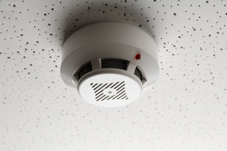 Smoke detector on light textured background, closeup. Alarm systemの写真素材
