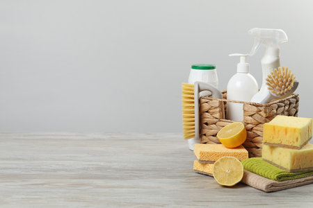 Eco-friendly cleaning products and supplies on wooden table, space for textの写真素材