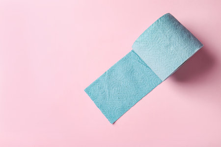 Blue toilet paper roll on light pink background, top view. Space for textの写真素材