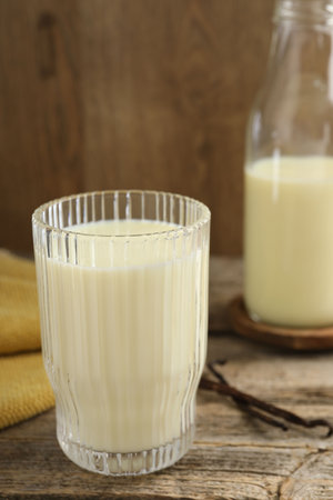 Delicious vanilla milk on wooden table, closeupの写真素材