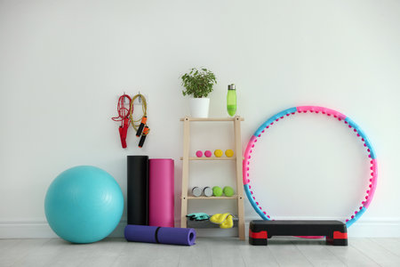 Different fitness equipment near white wall indoorsの写真素材