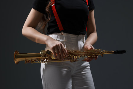 Musician with soprano saxophone on grey background, closeupの写真素材