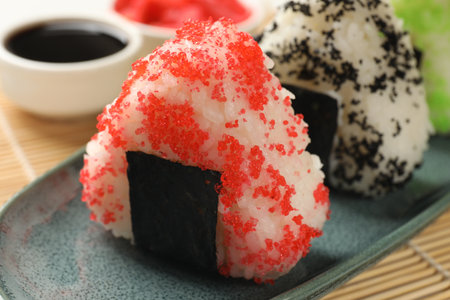 Tasty tobiko onigiri (Japanese rice balls) served on table, closeupの写真素材