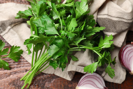 Fresh parsley and onion on wooden table, flat layの写真素材