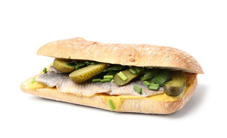 Tasty sandwich with herring, pickles, green onions and parsley on white backgroundの写真素材