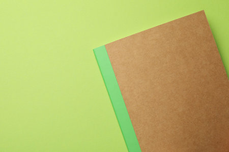 One copybook on green background, top view. Space for textの写真素材