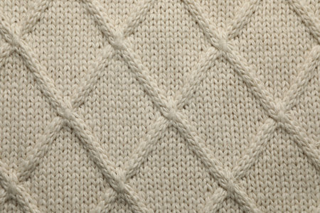 Beige knitted wool texture as background, top viewの写真素材