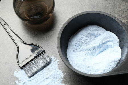 Bleaching powder and hairdresser's tools on grey table, closeupの写真素材