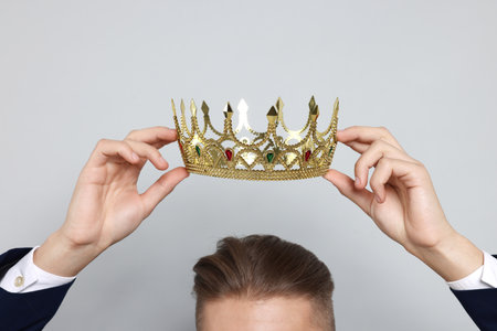Man wearing luxury crown on gray background, closeupの写真素材