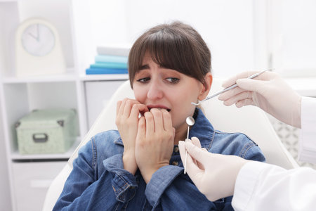 Scared woman having appointment with dentist in clinic