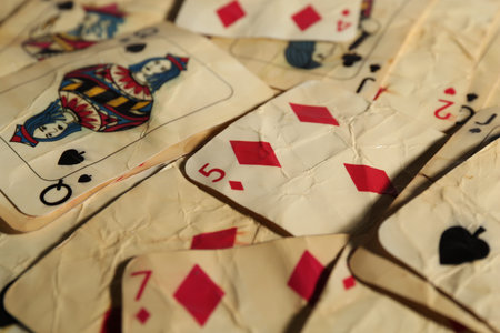 Old vintage playing cards as background, closeup