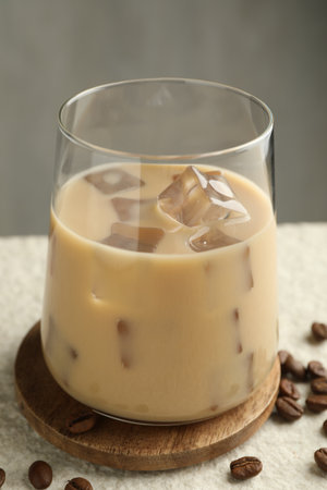 Coffee cream liqueur in glass and beans on white textured table, closeupの写真素材