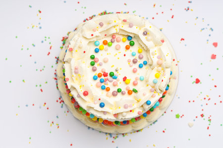 Delicious bento cake with colorful sprinkles on light table, top viewの写真素材