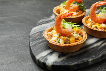 Tartlets with delicious filling on black table, closeup. Space for textの写真素材