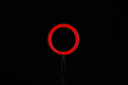 Ring lamp on stand against black backgroundの写真素材