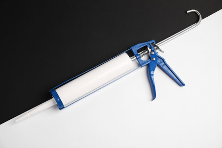 One glue gun on color background, top viewの写真素材