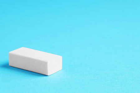 One eraser on light blue background, closeup. Space for textの写真素材