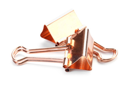 Two golden binder clips isolated on whiteの写真素材