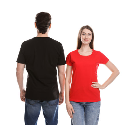 Woman and man wearing blank t-shirts on white background. Mockup for designの写真素材