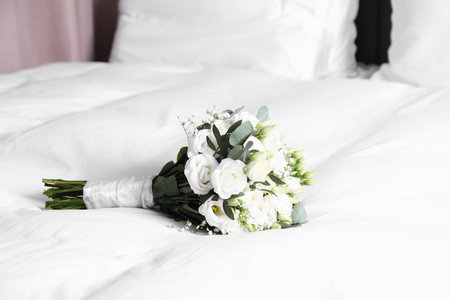 Wedding bouquet of beautiful flowers on bed indoorsの写真素材