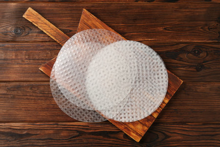 Edible rice paper sheets on wooden table, top viewの写真素材