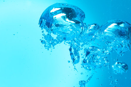 Many water bubbles on light blue background, closeupの写真素材